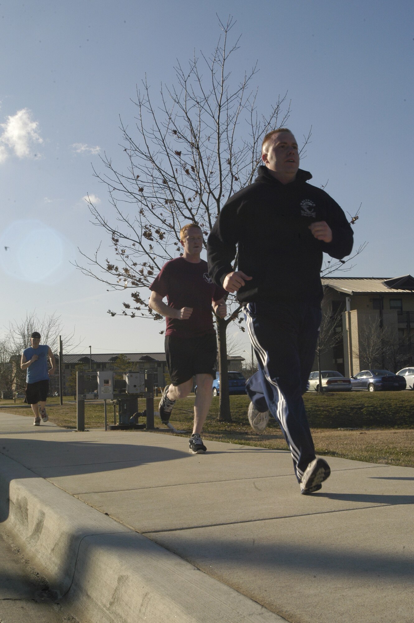 Airman 1st Class Tim Taffee, Airman 1st Class Thomas Patterson and Airman Basic Anthony Marty, 436th Aerial Port Squadron Mobility Flight stay fit by exercising outside of the Fitness Center during squadron physical training Jan. 18. (U.S. Air Force photo/Airman 1st Class Shen-Chia Chu)