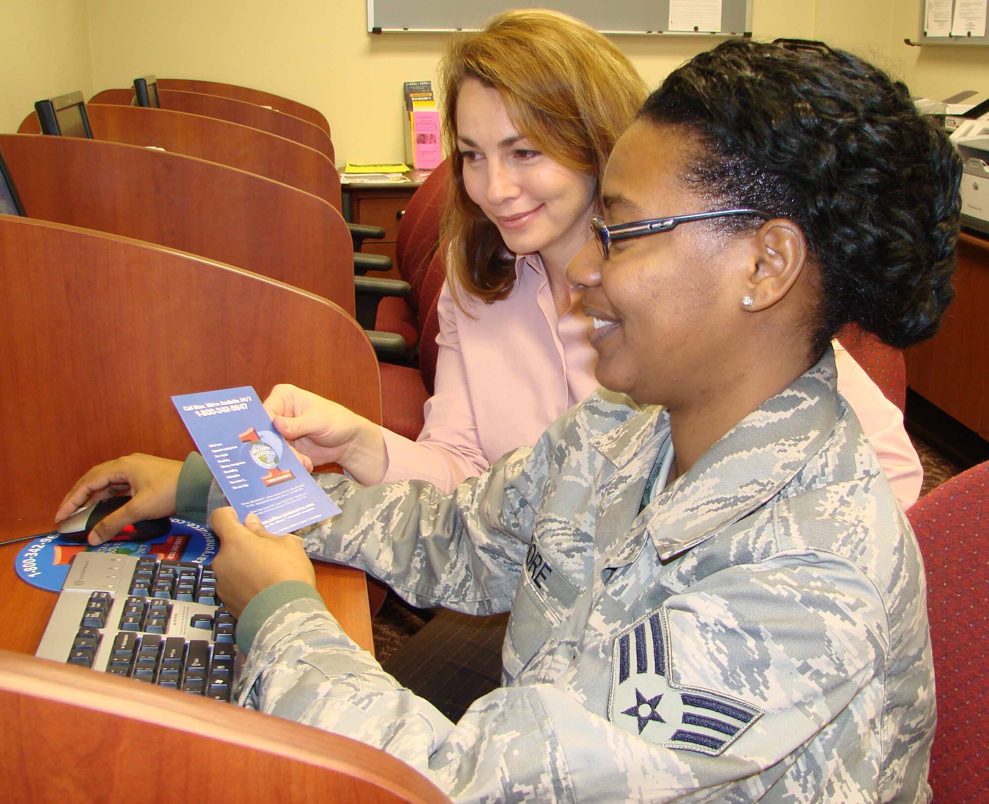 Beverly Pinero, Family Support Center community readiness consultant, helps A1C Kizze Moore, look up the Military OneSource Web site.  The Web site includes locators for education, child care, and elder care, online articles, referrals to military and community resources.  Military OneSource is provided by the Department of Defense at no cost to active duty, Guard and Reserve (regardless of activation status) and their families.
