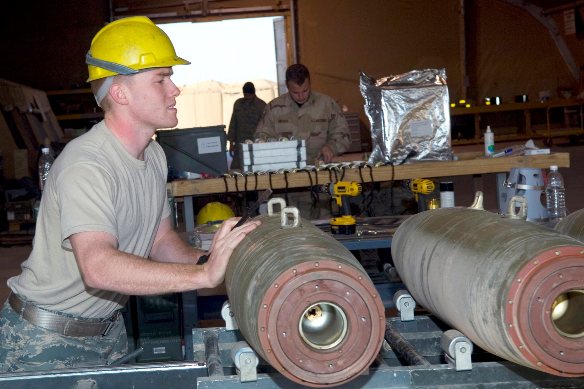 Airman 1st Class Justin Porter pushes a 500-pound MK-82 bomb down the munitions assembly conveyor for build-up Jan. 17 at Balad Air Base, Iraq. Airman Porter is a 332nd Expeditionary Maintenance Squadron Ammunitions Flight conventional maintenance crew member and deployed from Spangdahlem Air Base, Germany. (U.S. Air Force photo/Staff Sgt. Travis Edwards) 
