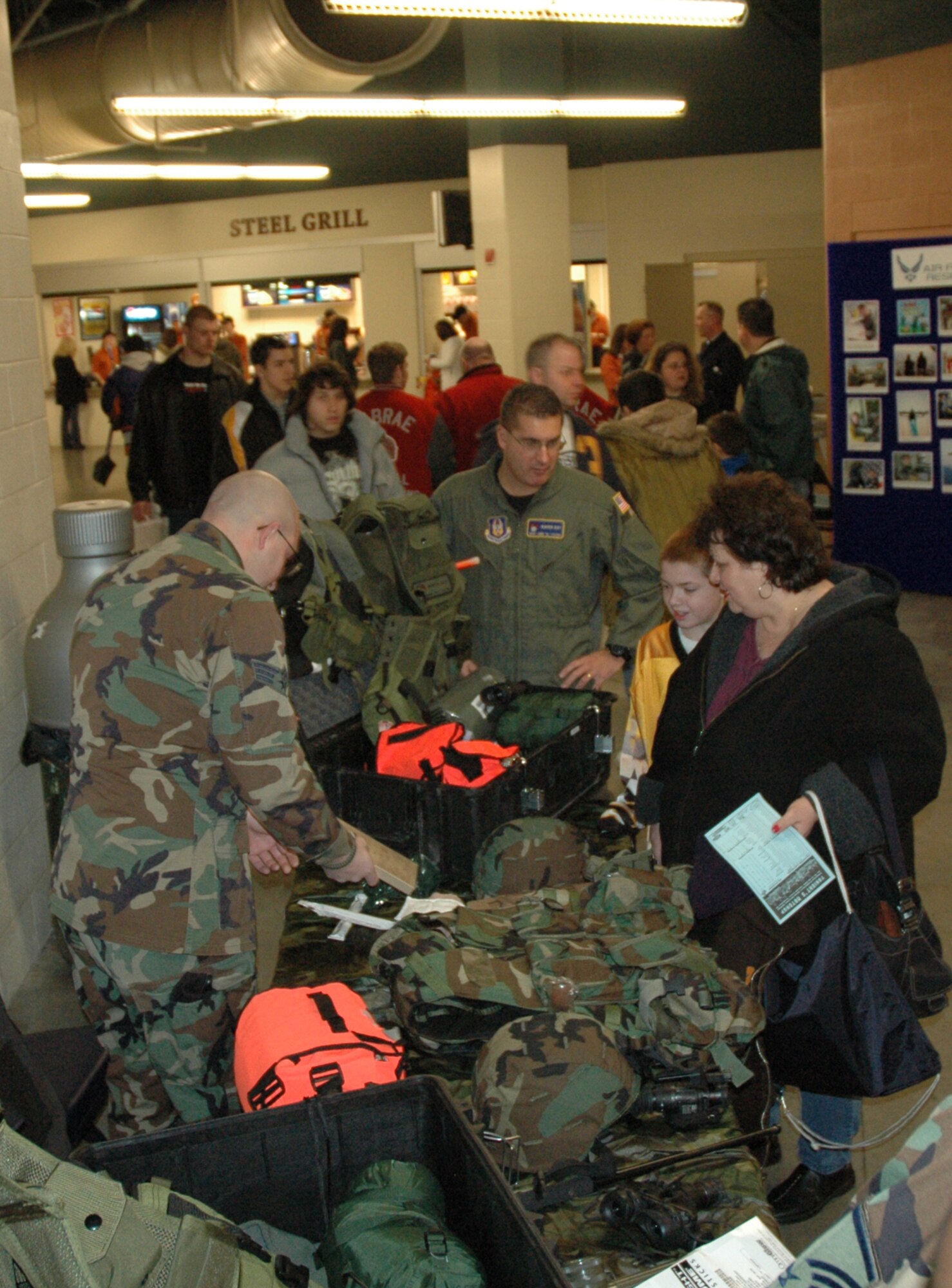 YOUNGSTOWN, Ohio – Hockey fans check out a military display provided by the Air Force Reserve's 910th Security Forces Squadron at the Chevrolet Centre in downtown Youngstown Jan. 19, 2008.  The display was provided as part of Military Night during the Youngstown Steelhounds hockey game versus the Shreveport Mudbugs. U.S. Air Force photo/Tech. Sgt. Bob Barko Jr.