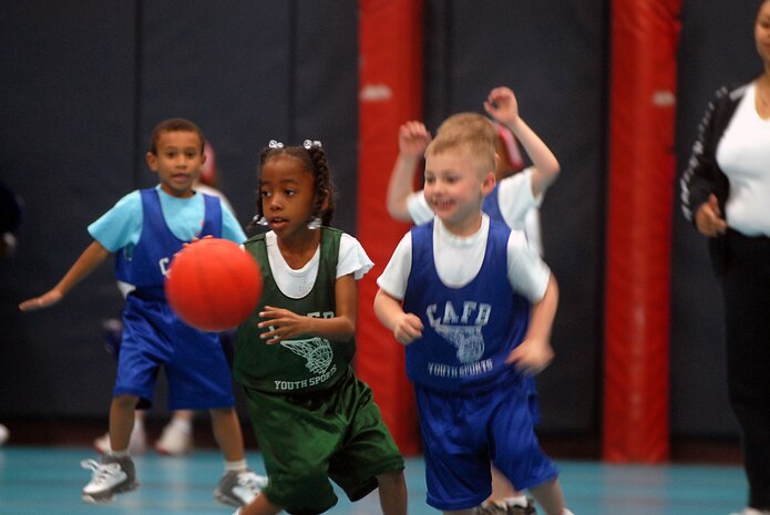 Sierra Rhone, 6, catches a rebound shot from the opposing team and dribbles down the basketball court at the Charleston AFB Youth Center Jan. 20. (U.S. Air Force photo/Tech. Sgt. Paul Kilgallon)