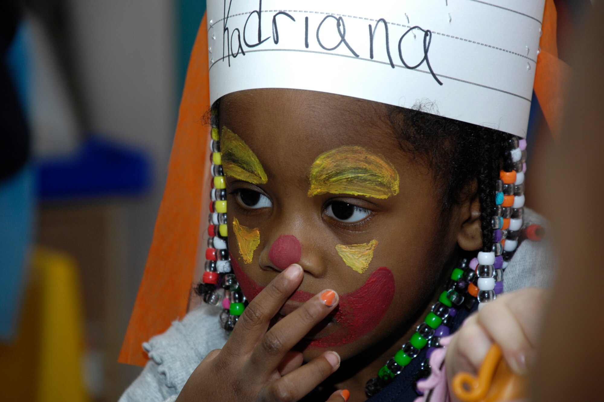 HANSCOM AFB, Mass. – Pre-school children from Room 9 at the Child Development Center had some face painting fun on Jan. 22. The children painted their faces and paraded around the center with musical instruments to serenade other classrooms. Pictured here Kadriana Jenkins examines her face paint in a mirror before joining in the parade. (U.S. Air Force photo by Linda LaBonte Britt)