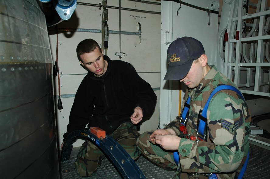 Senior Airman Harrison Roberts and Kyle Pressley, 341st Missile Maintenance Squadron MMT members, perform routine tasks in the payload transporter during a test to ensure the maintainers could still perform their duties with an added component in the vehicle.  A team from Vandenberg Air Force Base, Calif., visited Malmstrom from Jan. 9 to 16 to perform tests for the Payload Transporter Type III Security Enhancement Program. (U.S. Air Force photo/Airman 1st Class Emerald Ralston)