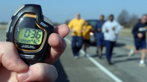 LANGLEY AIR FORCE BASE, Va. -- Airman 1st Class Richard Everidge, 1st Services Squadron apprentice, holds a timer as Sailors from the Precommissioning Unit, George H.W. Bush Aircraft Carrier, make their way to the finish line during the 5K Polar Bear Run here Jan. 23. The winners of the 5K are as follows: Women Under 34 category – Adonis White; Men Under 34 category – Jamal Lofton; Men 35-49 category – John DeGoes; Men 50 and Over category – George Hays. (U.S. Air Force photo/Airman 1st Class Vernon Young)