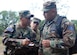 Tech. Sgt Herman Ybarra exchanges ideas with Salvadoran military members while they train for their upcoming deployment to support Operation Iraqi Freedom. Sergeant Ybarra was part of a U.S. task force from Soto Cano Air Base, Honduras, deployed to El Salvador to provide Salvadoran military members familiarization with U.S. equipment, tactics, techniques and procedures prior to their upcoming Operation Iraqi Freedom rotation. (U.S. Air Force Photo by Tech. Sgt. John Asselin)