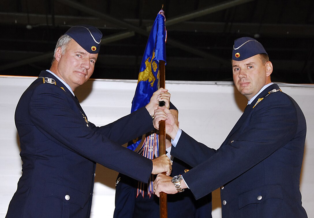 German air force Lt. Col. Christian Rode, right accepts command of the 88th Fighter Training Squadron Jan. 18 during a ceremony in Bldg. 2408. 80th Operations Group Commander Axel Pohlmann officiated the event. The outgoing commander was Lt. Col. Rick Davis. (U.S. Air Force photo/Harry Tonemah)