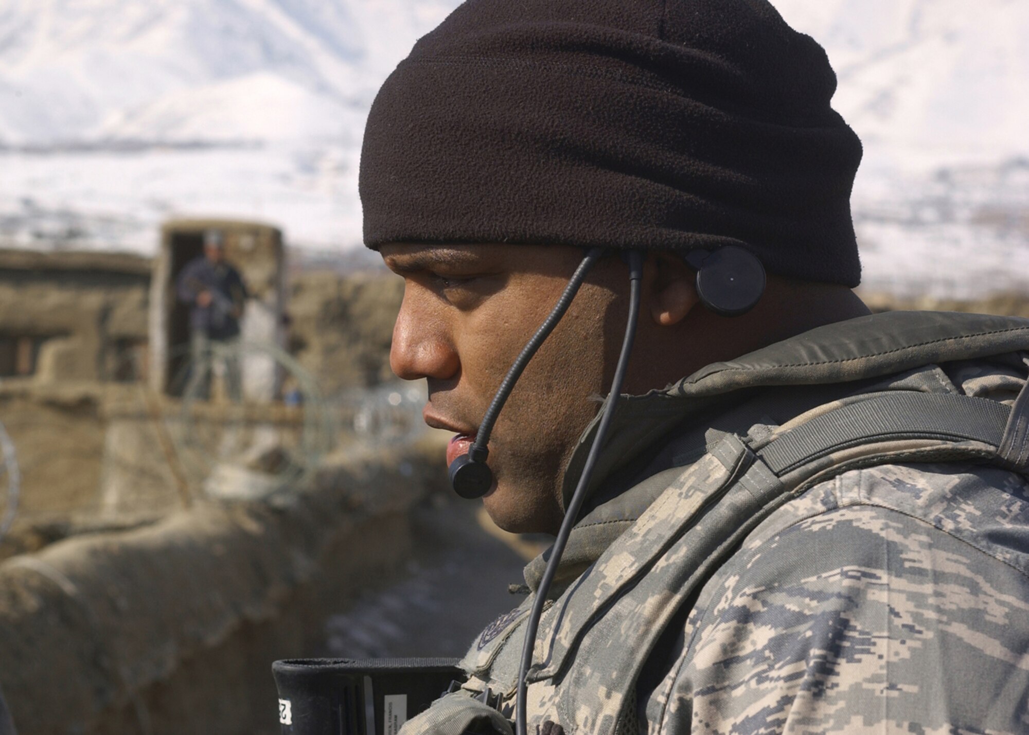 BAGRAM AIR BASE, Afghanistan -- Tech. Sgt. Francis Warren, Bagram Provincial Reconstruction Team member, monitors the fence line at a prison in the Charikar District of Afghanistan while doing an assessment of the facility Jan. 22.  The team gathers data for military and civilian officials to determine which areas need to be prioritized for reconstruction or improvements. Francis is deployed from the 11th Security Forces Squadron at Bolling Air Force Base, D.C. (USAF Photo by Master Sgt. Demetrius Lester)