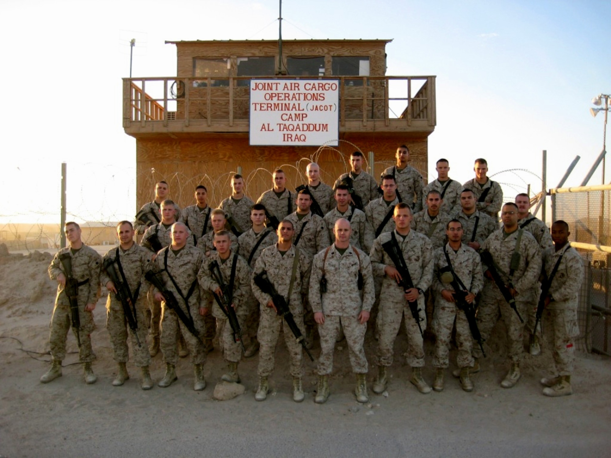 Gunnery Sgt. Jaimie Kilroy, 2nd Supply Battalion, 2nd Marine Logistics Group Landing Support Detachment chief, assembled his Marines for a photograph at the Joint Air Cargo Operations Terminal at Camp Al Taqaddum, officially known as Marine Corp Air Base Al Taqaddum, Iraq. Among the assigned Marines are nearly 50 Airmen, half of which are deployed from Dover Air Force Base. (Courtesy photo)
