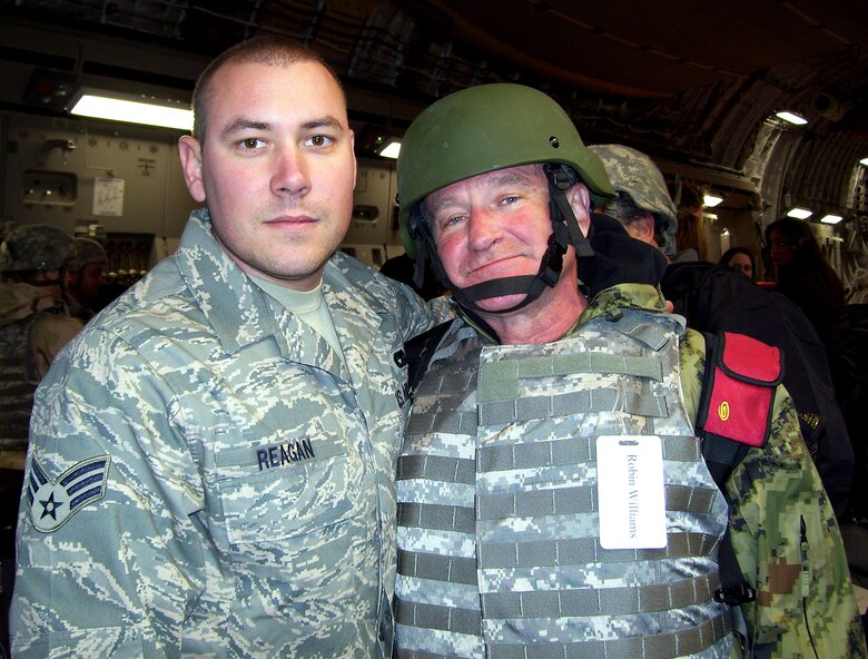 Senior Airman Adam Reagan, 332nd Expeditionary Logistics Readiness Squadron, Detachment 4, spends a few minutes getting to know Robin Williams, who visited Marine Corp Air Base Al Taqaddum, Iraq, as part of a United Service Organization tour. Airman Reagan, deployed from 436th Aerial Port Squadron is one of two dozen Airmen assigned to the Marine base who hail from Dover Air Force Base. In all, there are nearly 50 Airmen deployed to Al Taqaddum. (U.S. Air Force photo/Staff Sgt. Jodi Pepin)