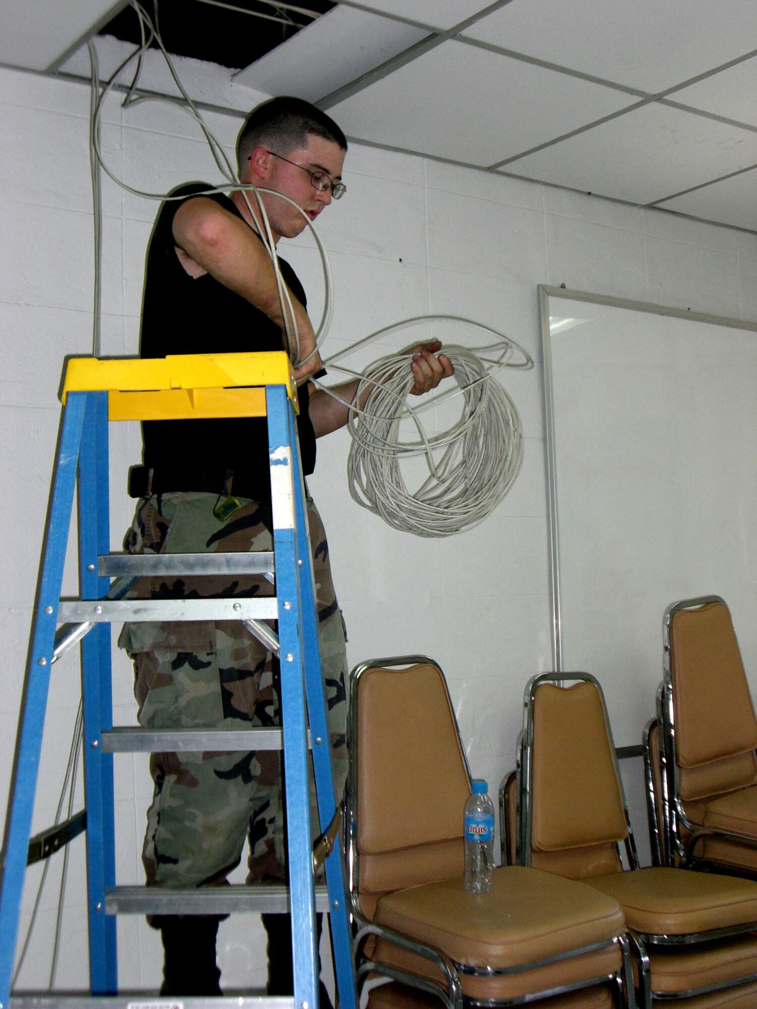 Senior Airman Christopher Reed runs a line from the ceiling into a computer for Internet connectivity in preparation for Cope Tiger 2008 Jan. 20 at Korat Royal Thai Air Base, Thailand. Airman Reed is a theater deployable communications infrastructure specialist from the 18th Communications Squadron from Kadena Air Base, Japan. (U.S. Air Force photo/Capt. Renee H. Lee) 
