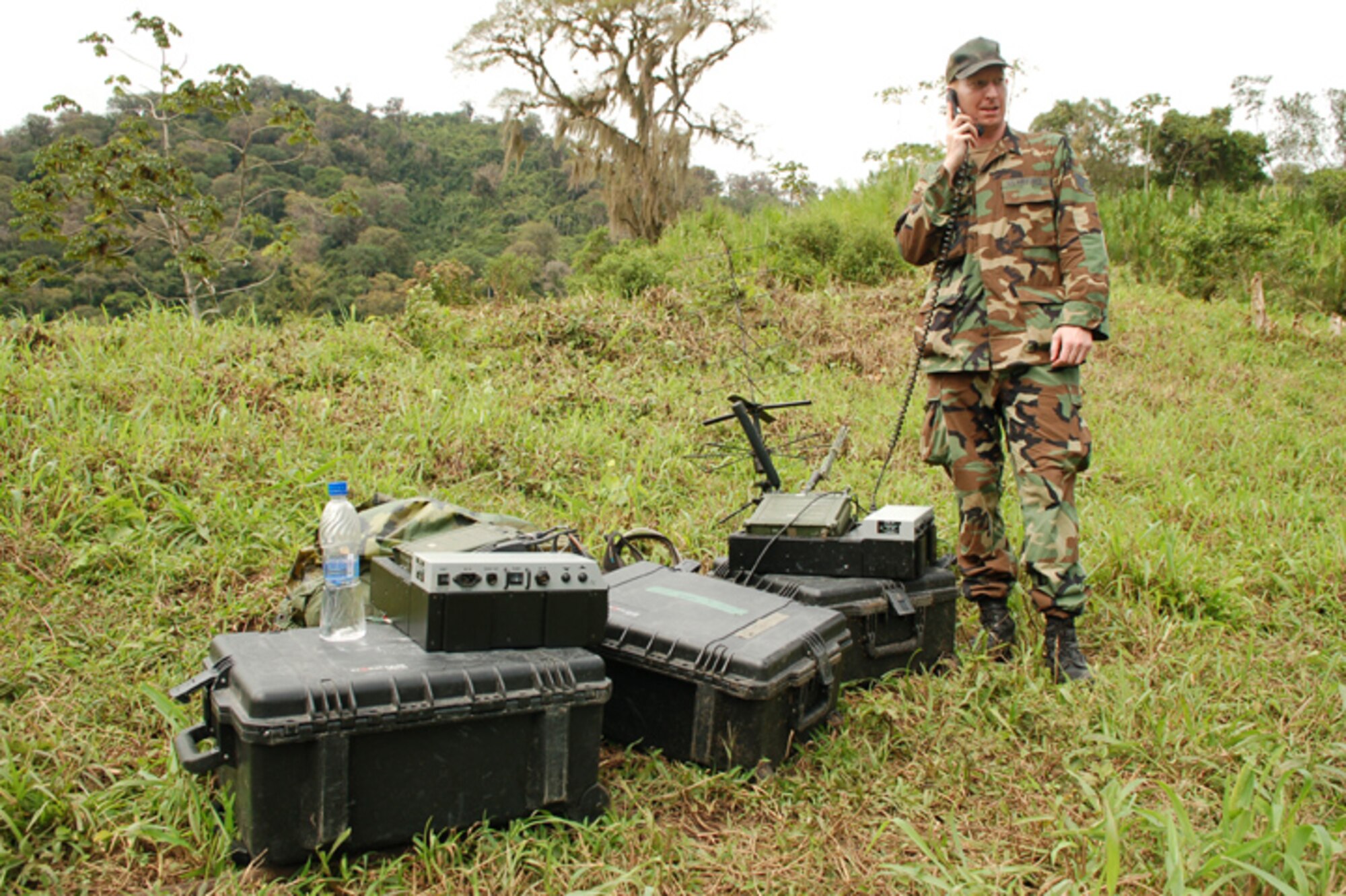 PIEDRA MESA, Costa Rica - Air Force Staff Sgt. Charles Alford, Joint Task Force-Bravo communications directorate, talks to operators in the JTF-Bravo Joint Operations Center from a village in the remote mountains of Costa Rica. The communications directorate, or J-6, recently began teaching servicemembers from various career fields how to use the communications equipment used on deployments to augment the small group of people qualified to operate it. (U.S. Air Force photo by Staff Sgt. Austin M. May) 