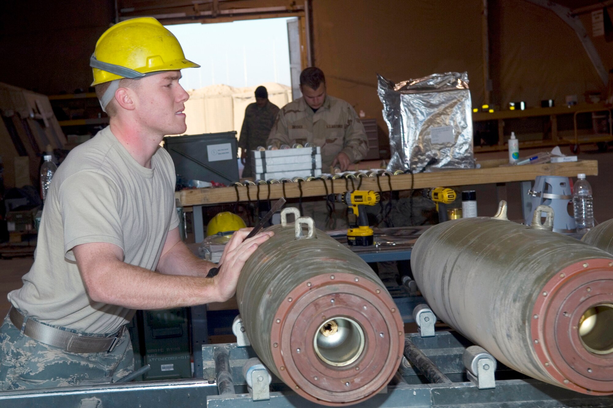 BALAD AIR BASE, Iraq -- Airman 1st Class Justin Porter, 332nd Expeditionary Maintenance Squadron Ammunitions Flight conventional maintenance crew member, pushes a 500-pound MK-82 bomb down the Munitions Assembly Conveyor for build-up. Airman Porter is deployed from Spangdahlem Air Base, Germany. (U.S. Air Force photo/ Staff Sgt. Travis Edwards)