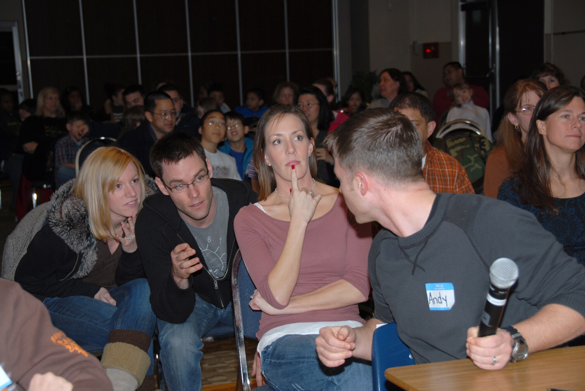 MISAWA AIR BASE, Japan - The Northsiders, from left to right, September Hughes, Bryan Hughes, Jennifer Morrow and Andy Morrow, confer about the answer to a question during the "Are You Smarter Than A 5th Grader" competition at the Mokuteki Community Center Jan. 19, 2008. Competing teams were tested on a variety of fifth-grade level questions put together by the library staff. (U.S. Air Force photo by Staff Sgt. Rachel Martinez)