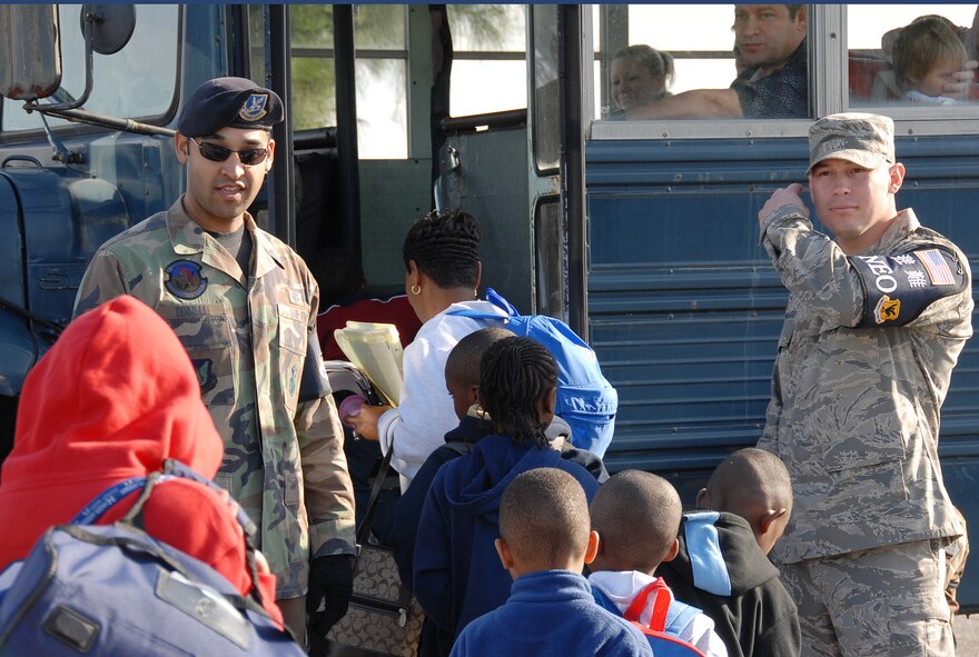 Senior Airman Richard Terrell, 18th Security Forces Squadron, and Senior Airman Joshua Alvarado, 18th Equipment Maintenance Squadron, check IDs and passports of evacuees during a PACAF IG inspection of non-combatant evacuation operation procedures at Kadena Air Base, Japan, Jan. 19.  The 18th Wing exercise from Jan. 18 to 20 tested the wing's ability to evacuate families during emergency situations. (U.S. Air Force photo/Tech. Sgt. Anthony Iusi) 
