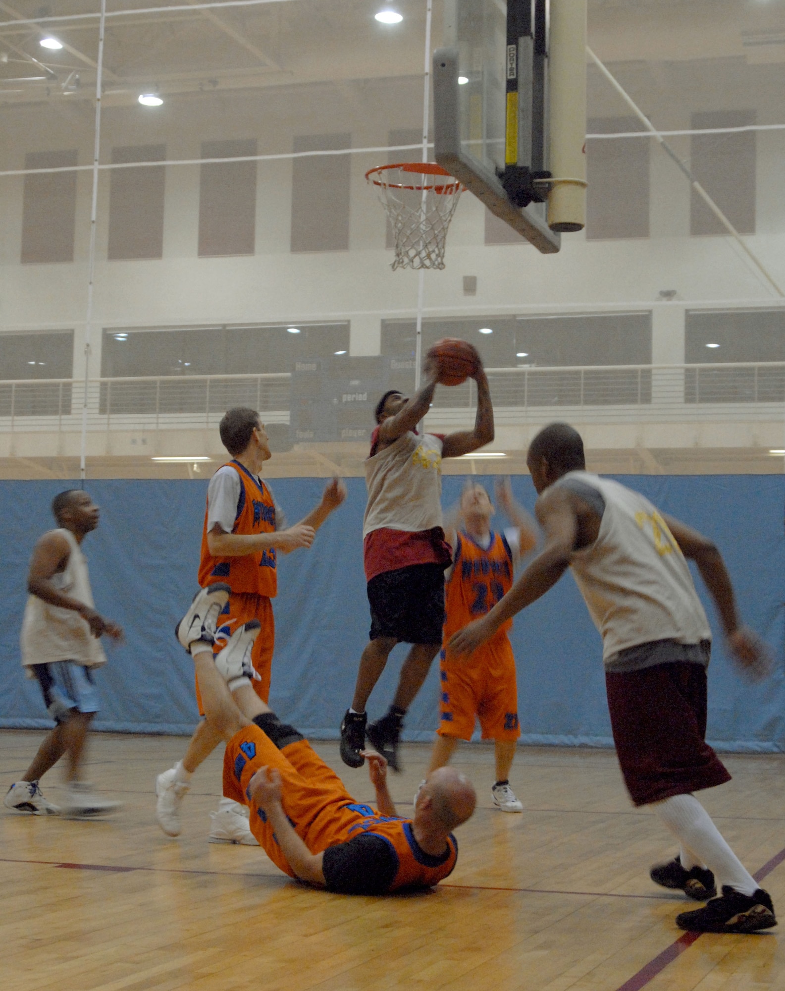 KUNSAN AIR BASE, South Korea -- Gregory Sweitzer, 8th Medical Group Medics, takes a fall as Irving Lucas, 8th Mission Support Squadron Warriors, goes for the basket during the over 30 basketball play-offs here Jan. 24.  The Medics were defeated by the Warriors 55 to 95.  Intramural sports are an excellent opportunity for Airmen to build espirit de corp while embracing the Air Force's "Fit to Fight" concept.  (U.S. Air Force photo/Staff Sgt. Darcie Ibidapo)