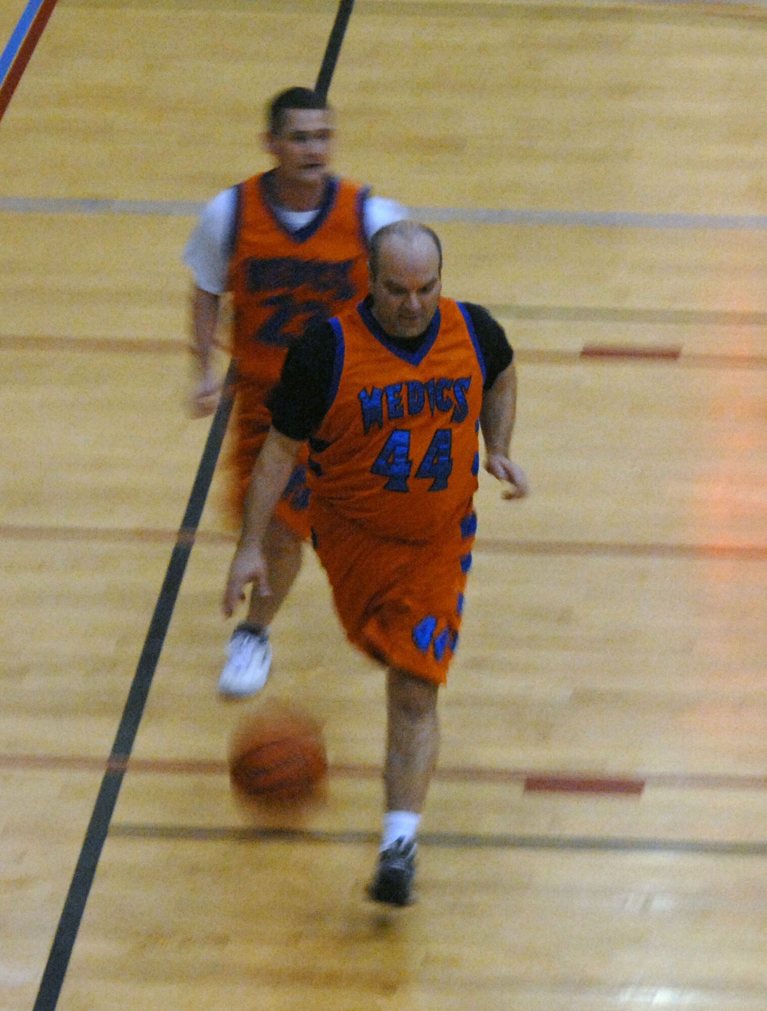 KUNSAN AIR BASE, South Korea -- Gregory Smith, 8th Medical Group Medics, dribbles down the court as teammate Timothy Meganhart follows during an over 30 basketball play-off game against the 8th Mission Support Squadron Warriors here Jan. 24.  The Medics were defeated by the Warriors 55 to 95.  Intramural sports are an excellent opportunity for Airmen to build espirit de corp while embracing the Air Force's "Fit to Fight" concept.  (U.S. Air Force photo/Staff Sgt. Darcie Ibidapo)