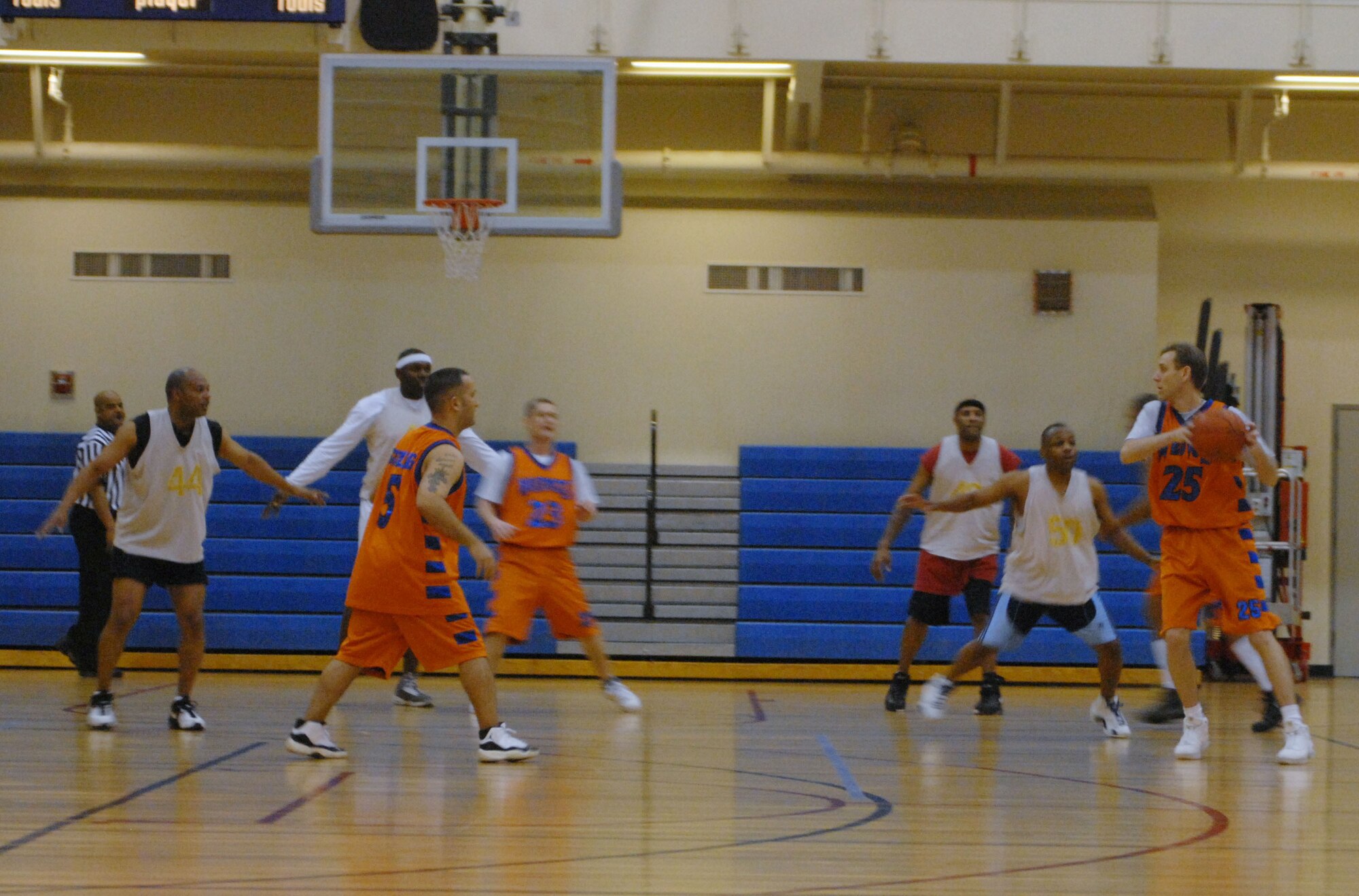 KUNSAN AIR BASE, South Korea -- Matthew Ostler, 8th Medical Group Medics, passes the ball to his teammate Eric Stailing during an over 30 basketball play-off game against the 8th Mission Support Squadron Warriors here Jan. 24.  The Medics were defeated by the Warriors 55 to 95.  Intramural sports are an excellent opportunity for Airmen to build espirit de corp while embracing the Air Force's "Fit to Fight" concept.  (U.S. Air Force photo/Staff Sgt. Darcie Ibidapo)