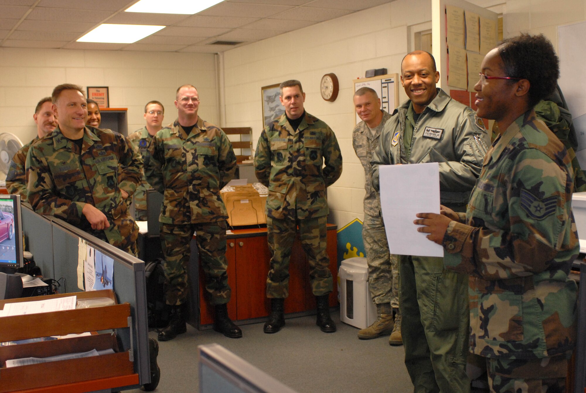 KUNSAN AIR BASE, South Korea -- Colonel CQ "Wolf" Brown, 8th Fighter Wing commander, congratulates Staff Sgt. Andrea Penn, 8th Maintenance Operations Squadron, NCO in charge of exercise and contingency programs here Jan. 25. Sergeant Penn was selected as the 8th Fighter Wing's Pride of the Pack for the week of Jan. 20. 