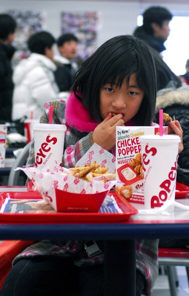 KUNSAN AIR BASE, South Korea -- An English camp student eats lunch at the base food court during her tour visit Jan. 23 here. The tour is part of the Good Neighbor Program that aims to enhance the relationship between the local community and Airmen assigned to Kunsan. (U.S. Air Force photo/Senior Airman Giang Nguyen)