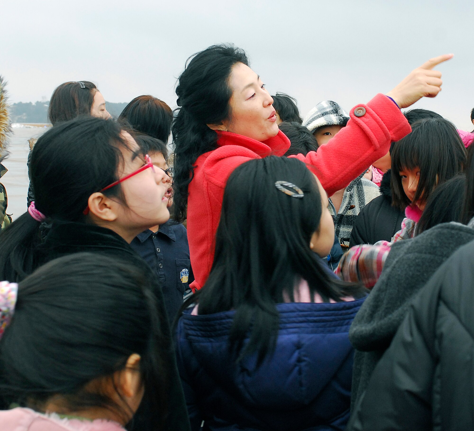 KUNSAN AIR BASE, South Korea -- Mrs. Rosemary Song, 8th Fighter Wing public affairs, guides a tour for Korean English camp students here Jan 23.  The tour is part of the Good Neighbor Program that aims to enhance the relationship between the local community and Airmen assigned to Kunsan. (U.S. Air Force photo/Senior Airman Giang Nguyen)
