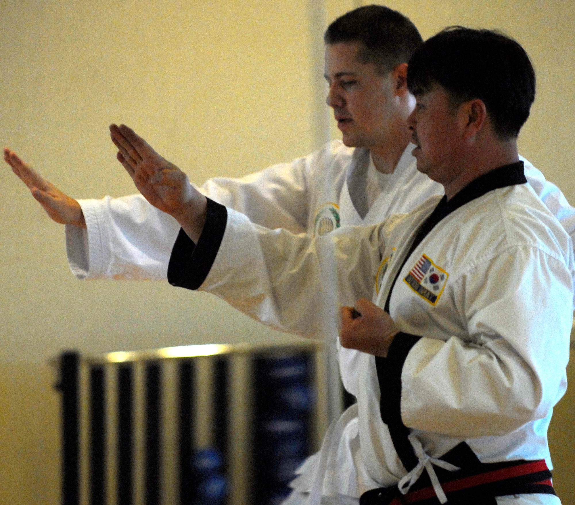 KUNSAN AIR BASE, South Korea -- Technical Sgt. Thomas Miller, 8th Operation Support Squadron and Master Ch'oe Ki Un practice martial arts Jan. 24 here.  Tang Soo Do class is part of the fit to fight programs designed to improve Airmen's physical well being offered at the base fitness center. (U.S. Air Force photo/Senior Airman Giang Nguyen)