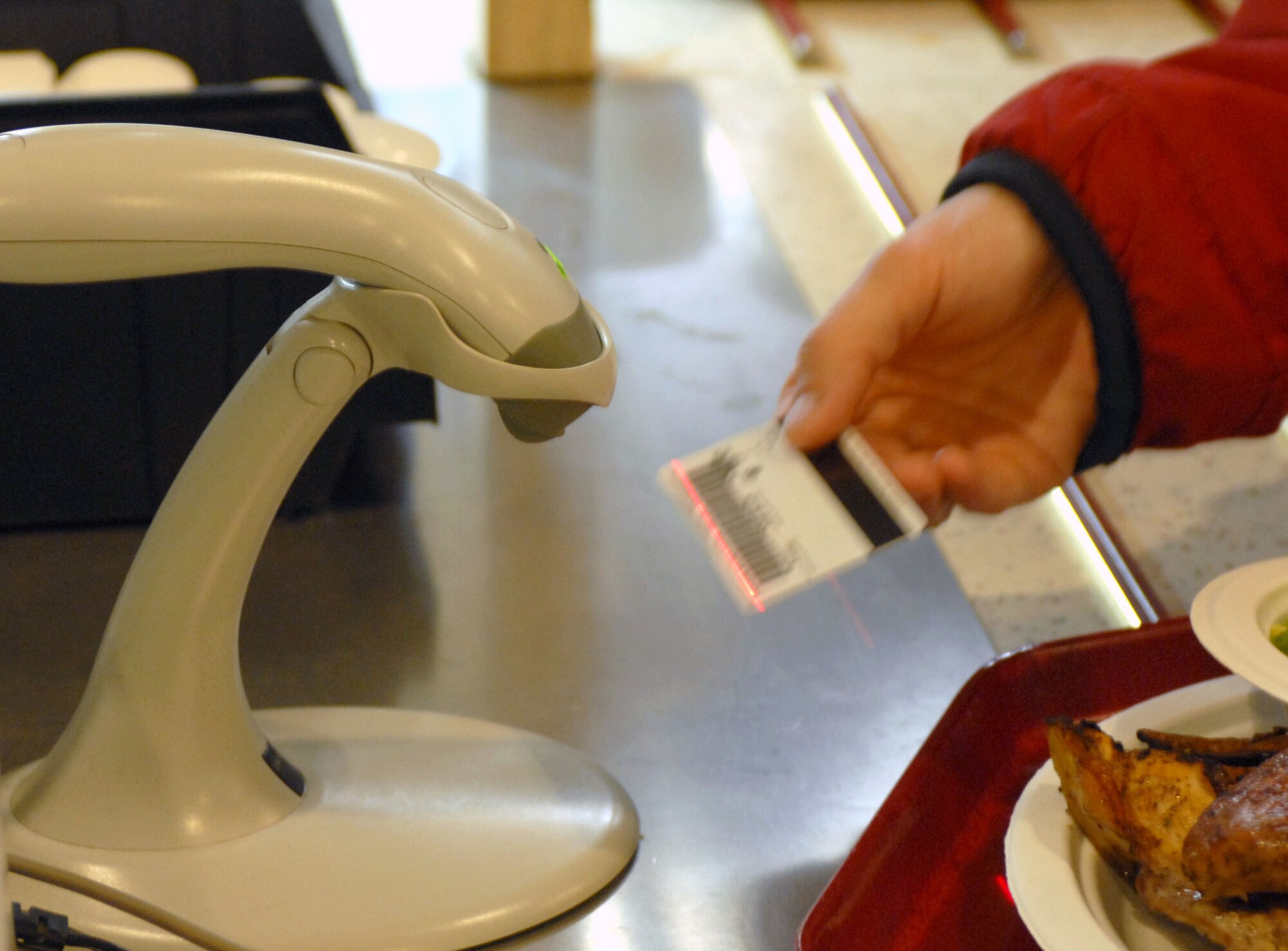 KUNSAN AIR BASE, South Korea -- An Airman scans her identification card to pay for lunch at the O'Malley Dining Facility Jan. 24 here.  The O'Malley Dinging Facility is open for breakfast, lunch, dinner and a midnight meal for about 2,500 Airmen and Soldiers providing them the proper nutrition to remain mission ready. (U.S Air Force photo/Senior Airman Steven R. Doty) 