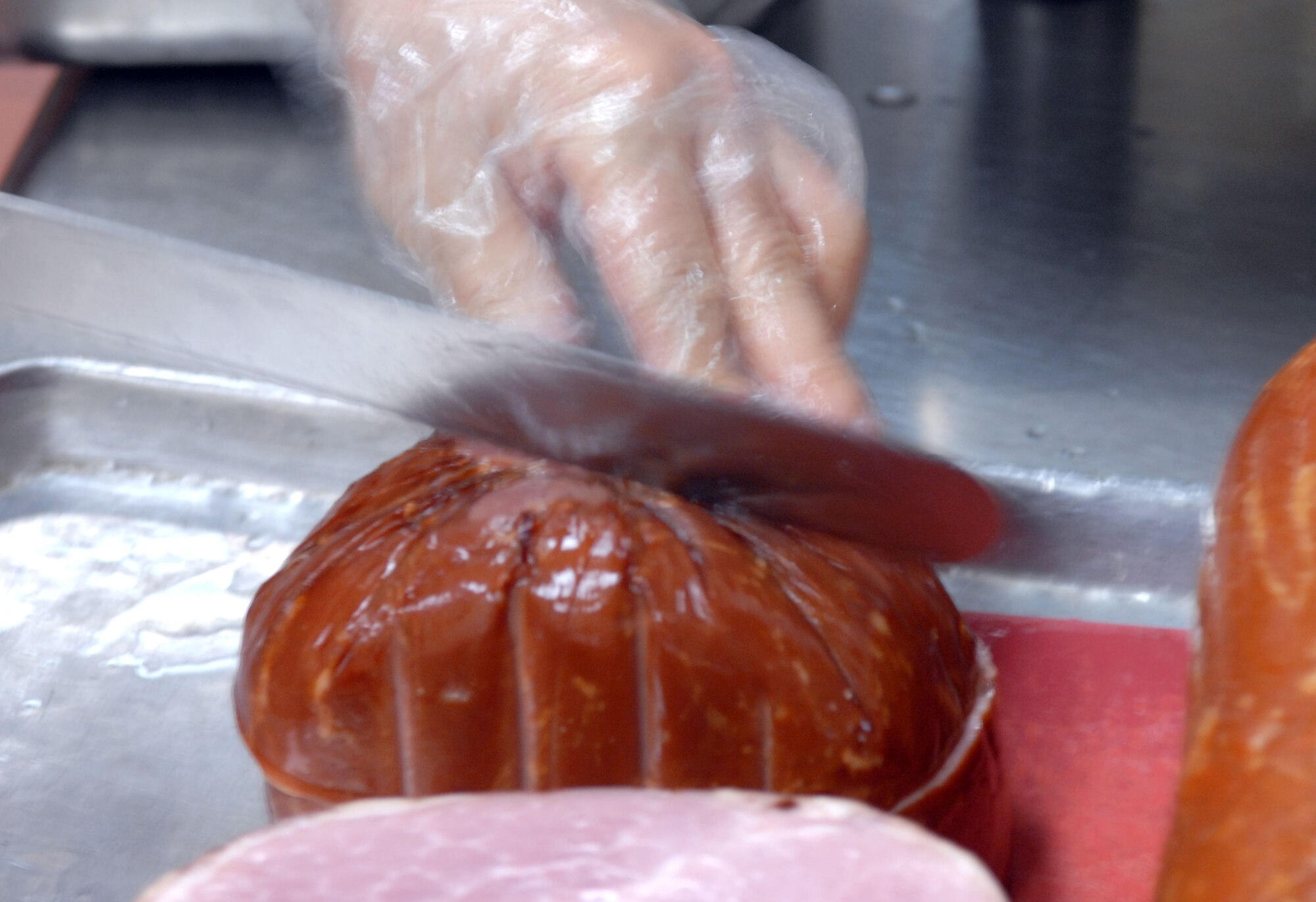 KUNSAN AIR BASE, South Korea -- A Pacific Architect Engineering Korea Limited employee prepares food for lunch at the O'Malley Dining Facility Jan. 24 here.  The O'Malley Dinging Facility is open for breakfast, lunch, dinner and a midnight meal for about 2,500 Airmen and Soldiers providing them the proper nutrition to remain mission ready. (U.S Air Force photo/Senior Airman Steven R. Doty) 