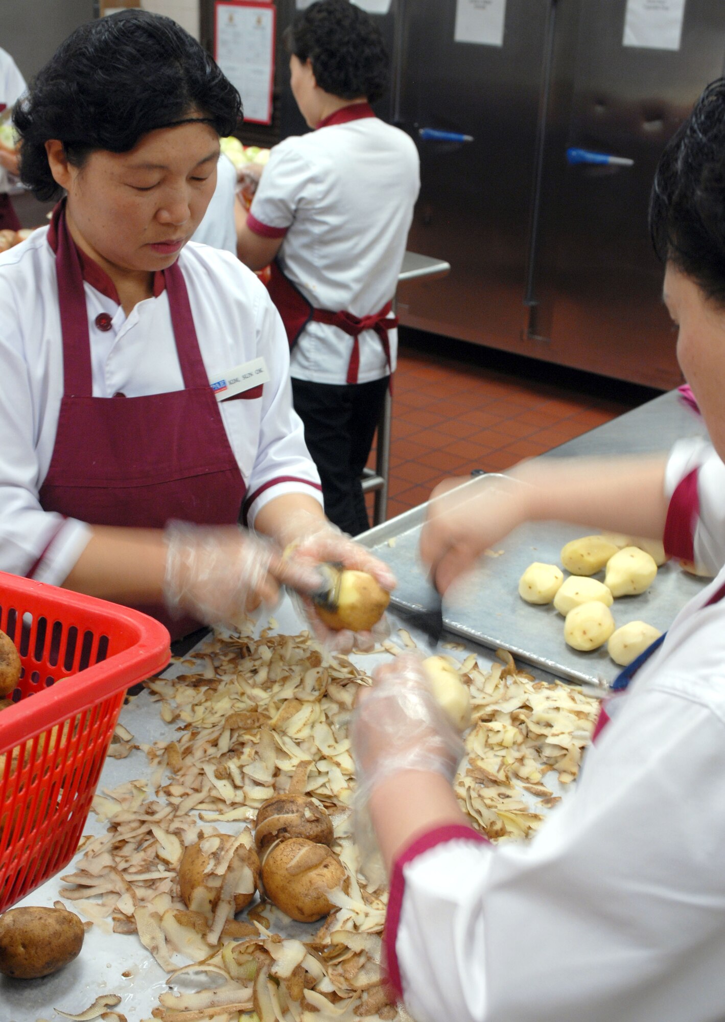 KUNSAN AIR BASE, South Korea -- Employees of Pacific Architect Engineering Korea Limited prepares food for lunch at the O'Malley Dining Facility Jan. 24 here.  The O'Malley Dinging Facility is open for breakfast, lunch, dinner and a midnight meal for about 2,500 Airmen and Soldiers providing them the proper nutrition to remain mission ready. (U.S Air Force photo/Senior Airman Steven R. Doty) 