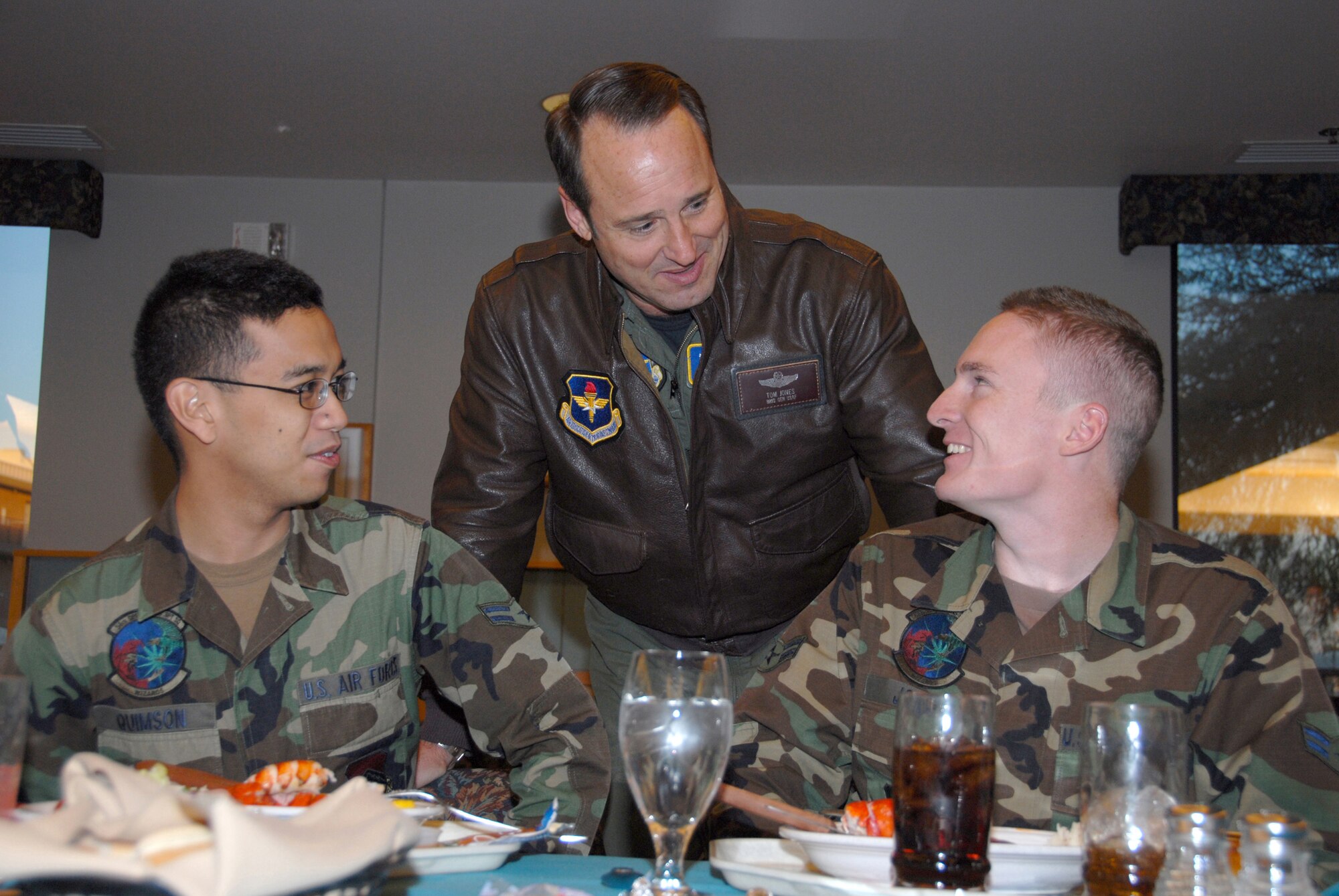 Brig. Gen. Tom Jones, 56th Fighter Wing commander, greets Airmen 1st Class Lord Quimson, left, and Josh Jobe, 56th Operations Support Squadron at the Luke Airman’s birthday meal Jan. 17. The meal is provided to Airmen living in the
dorms who are having a birthday during that quarter. It is put on by the 56th Services Squadron and supported by Luke’s Top 3 organization, Air Force Sergeant’s Association, The Luke Airmen’s Fund and the Company Grade Officers’ Council. (photo by Airman First Class David Bulkley)