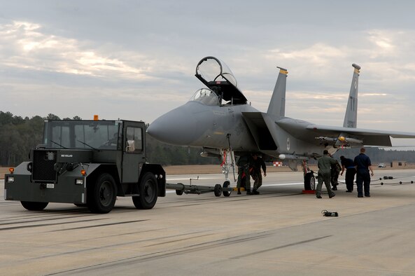 MOODY AIR FORCE BASE, Ga. -- Members of the 23rd Equipment Maintenance Squadron crash recovery team prepare to tow an F-15C Eagle off of Moody's runway after Jan. 24. The aircraft flew in from Tyndall AFB, Fla., to perform an arresting system certification. (U.S. Air Force photo by Airman 1st Class Brittany Barker) 


