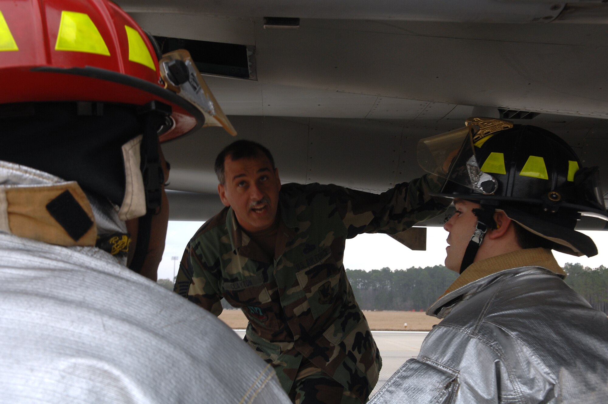 MOODY AIR FORCE BASE, Ga. -- Fire fighters from the 23rd Civil Engineering Squadron listen to Master Sgt. Roy Clayton, 23rd Equipment Maintenance Squadron crash recovery technician, explain safety aspects of the F-15C Eagle after it arrives here Jan 24. The aircraft flew in from Tyndall AFB, Fla. to perform an aircraft arresting system certification and emergency responder training. (U.S. Air Force photo by Airman 1st Class Brittany Barker) 
