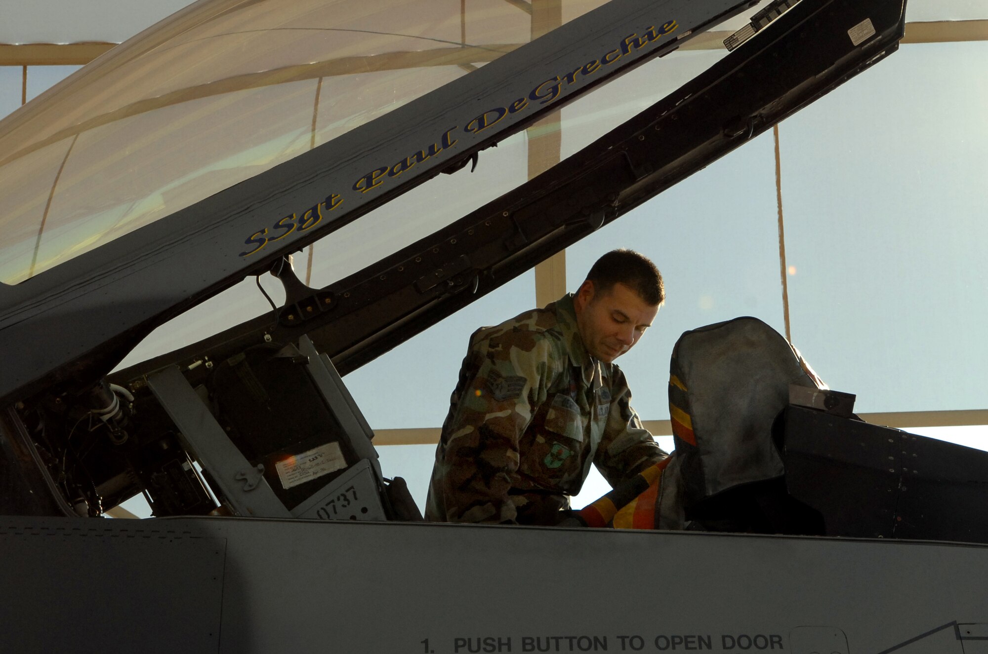 Staff Sgt. Paul DeGrechie, 63rd Aircraft Maintenance Unit crew chief, attaches covers to the flagship cockpit after a flight Jan. 18. (photo by Airman First Class C.J. Hatch)