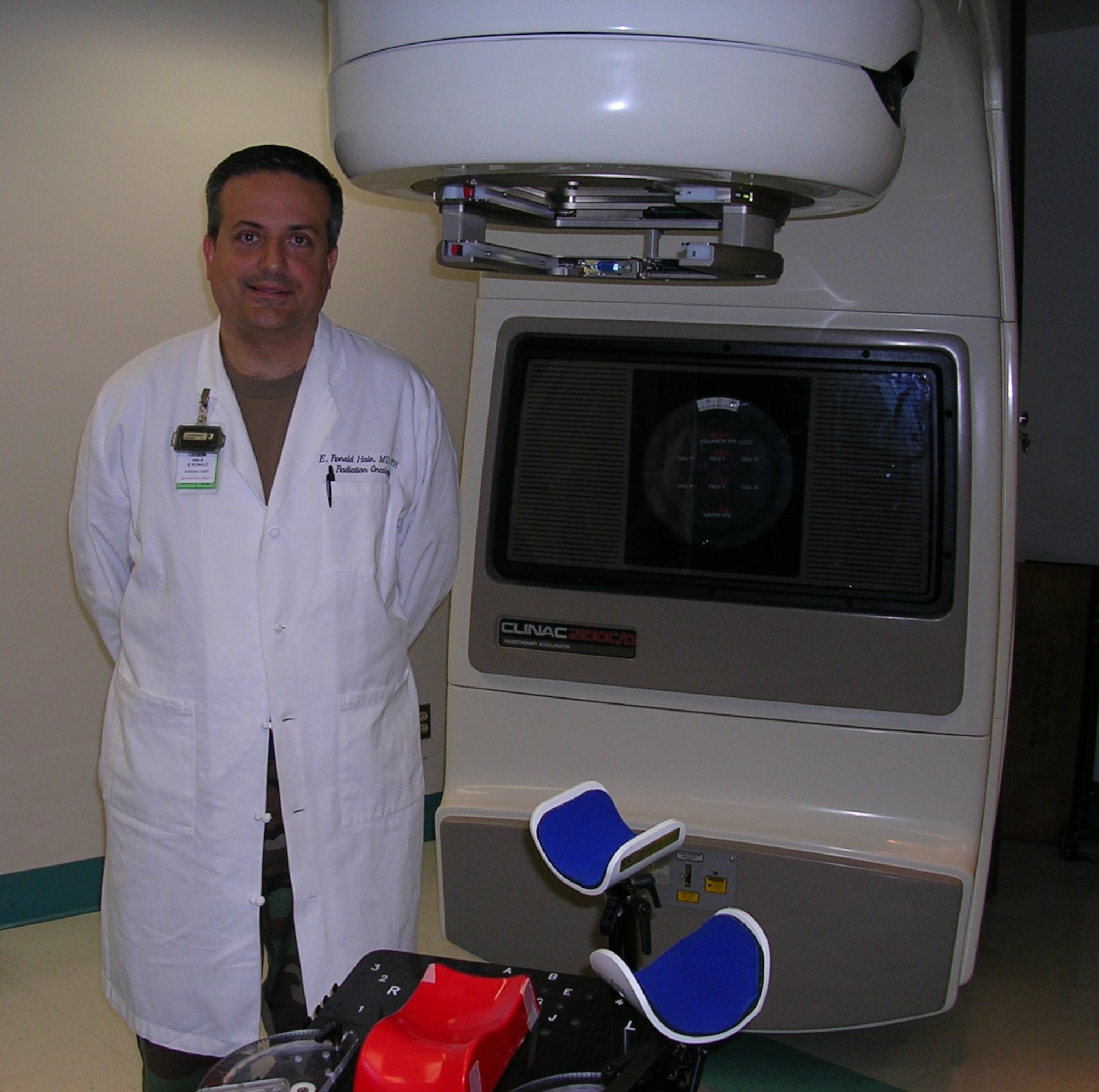 The Linear Accelerator, seen here next to Dr. (Lt. Col.) E. Ronald Hale, MD, MPH, Chief of Radiation Oncology, Wright-Patterson Medical Center Cancer Care, is a state of the art computer controlled system used to treat a cancer with pin-point precision. The Wright-Patterson Medical Center Cancer Care program recently received accreditation with commendation by the American College of Surgeons’ Commission on Cancer, the highest designation given by the CoC.  (Air Force photo by Mike Frangipane)