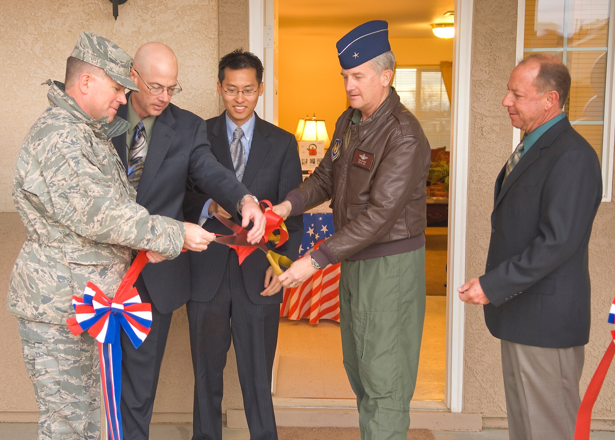 From left to right: Col. Bryan Gallagher, 95th Air Base Wing commander; James Judkins, director of the 95th Civil Engineer and Transportation Directorate; Vince Fong, representative for 22nd District U.S. Rep. Kevin McCarthy; Brig. Gen David Eichhorn, Air Force Flight Test Center commander and Joe Palko, Hunt Building Company project superintendent, cut the ribbon to open the Tamarisk Plains housing area here Jan. 22. Tamarisk Plains replaced 67 concrete houses built in 1949 with 60 modern homes for company grade officers. (Photo by Mike Cassidy)