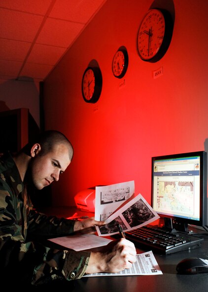 Airman Joseph Newlon reviews significant weather depictions from the 17th Operational Weather Squadron at Hickam Air Force Base, Hawaii, Jan. 22 at Offutt Air Force Base, Neb. Airman Newlon from Keokuk, Iowa, is a broadcast weather technician at the American Forces Network Weather Center. (U.S. Air Force photo/G. A. Volb)
