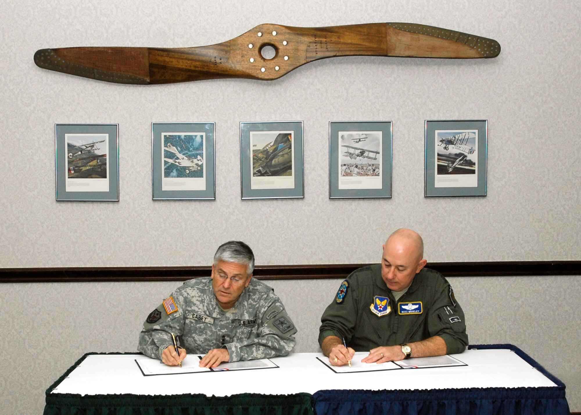 Army Chief of Staff Gen. George W. Casey Jr. (left), and Air Force Chief of Staff Gen. T. Michael Moseley sign a memorandum of agreement during the "Warfighter Talks" held Jan. 23 at Bolling Air Force Base, D.C. The two generals met to discuss interdependency and interoperability between the Army and Air Force. (U.S. Air Force photo/Michael Pausic) 
