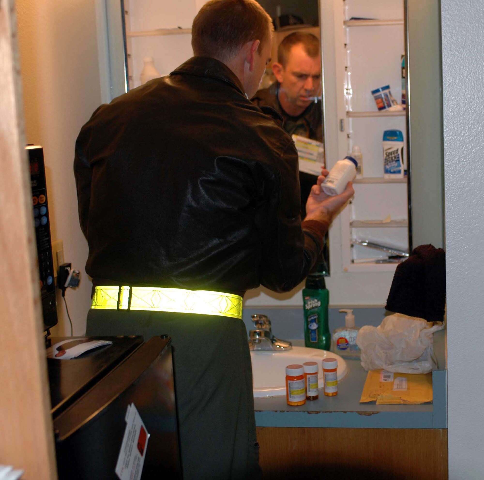 A member of Travis leadership inspects a dorm room during Operation Nighthawk Jan. 19. Operation Nighthawk is a Team Travis leadership program used to provide a Health, Morale and Welfare check with feedback to leadership on the status and activities of members of the installation, their families and visitors to the base. (U.S. Air Force photo/Tech. Sgt. Donald Osborn)