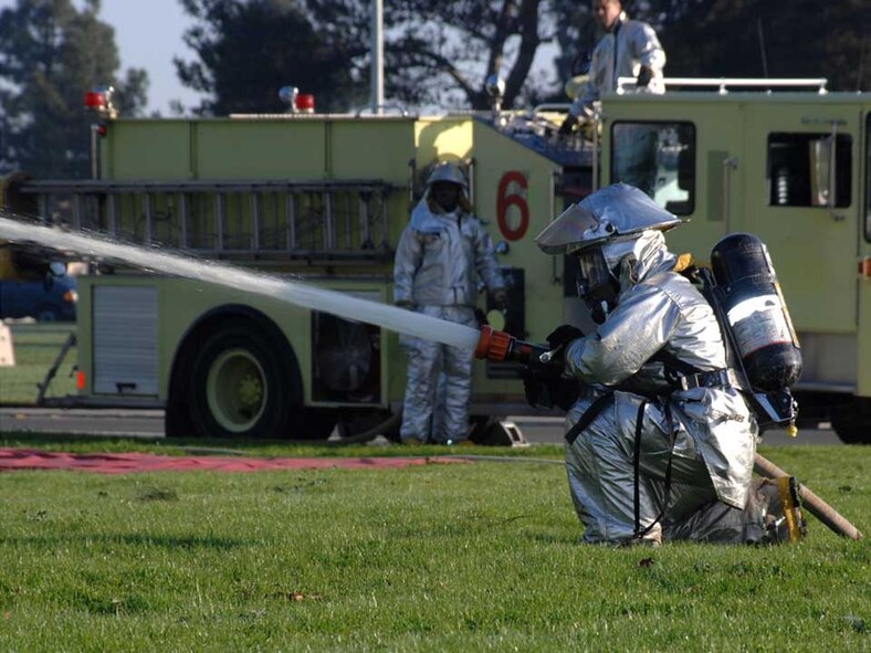 A Travis Firefighter responds during the Emergency Management Exercise Jan. 15. The exercise was held in preparation for the Unit Compliance Inspection in March when Travis will host more than 130 inspectors who will assess Travis’ adherence with by-law requirements, executive orders, DOD directives, Air Force and MAJCOM instructions. (U.S. Air Force photo/Laura Fentress)