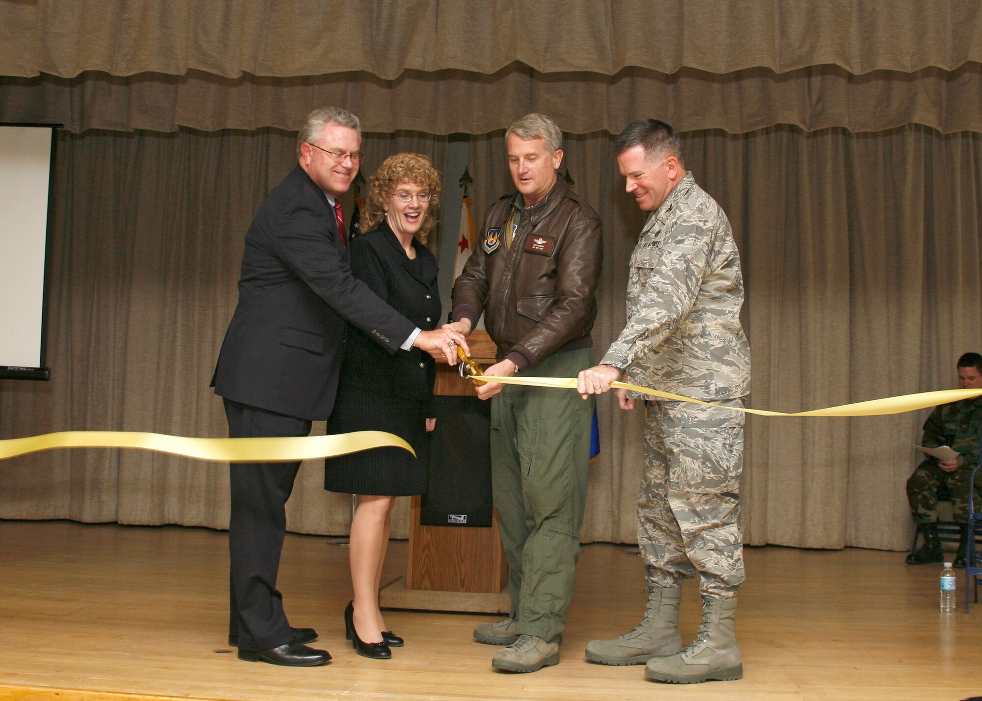 From left to right: Rob Challinor, Muroc Joint Unified School District superintendent; Cathi Cleveland, Muroc School Improvemnt Partnership president; Brig. Gen. David Eichhorn, Air Force Flight Test Center commander and Col. Bryan Gallagher, 95th Air Base Wing commander, cut the ribbon to officially open the Center of Excellence here Jan. 22. The Center of Excellence is an education center that will cater to adults and children for educational advancements. (Photo by Jet Fabara)