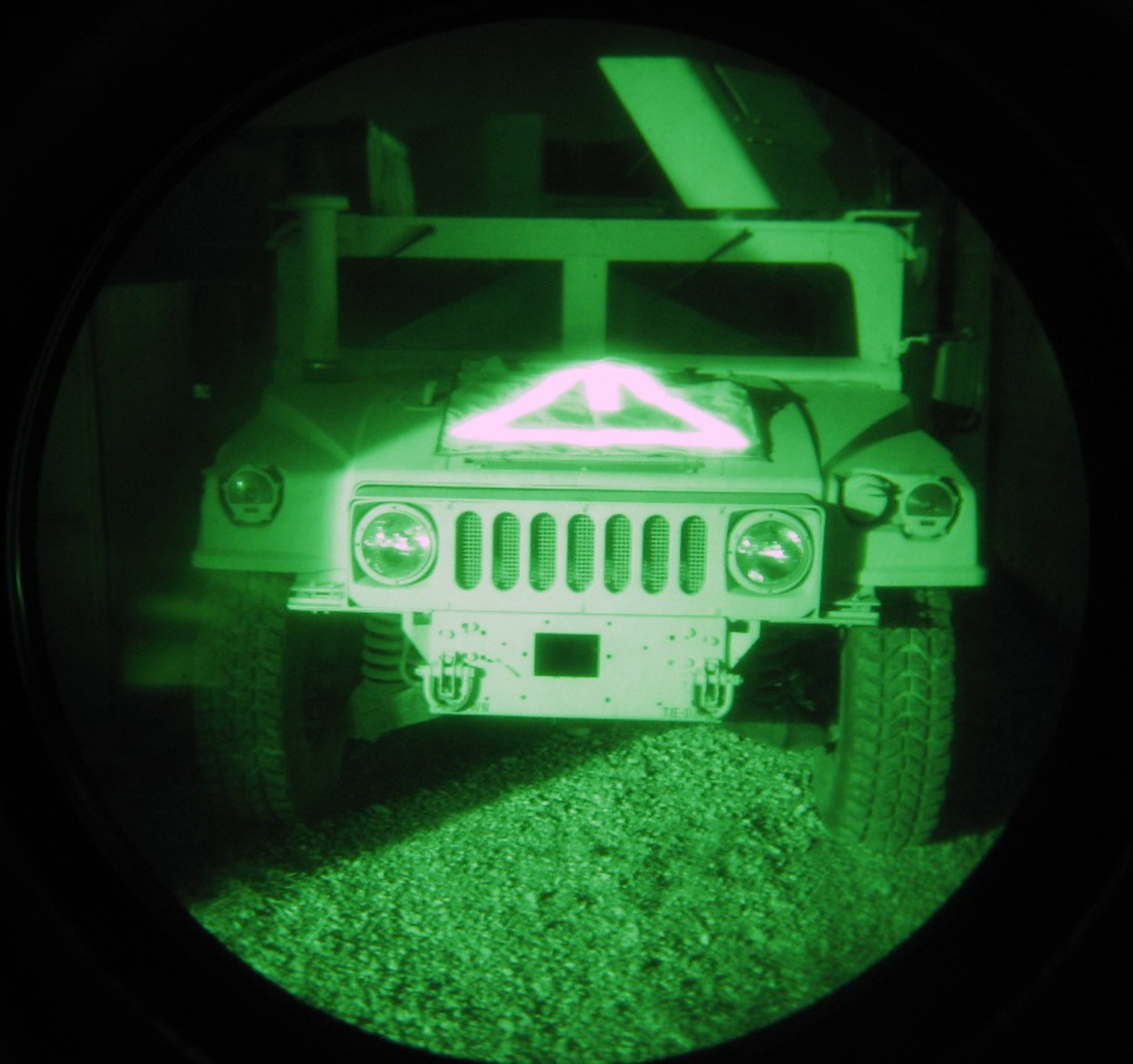 A military vehicle marked with Target Recognition Operator Notification I (small strip in the center) and TRON III is shown through night-vision googles in January near Bagram Air Base, Afghanistan. The identification technology was developed by Air Force Research Laboratory officials in collaboration with the civilian industry to support joint warfighters. (U.S. Air Force photo) 
