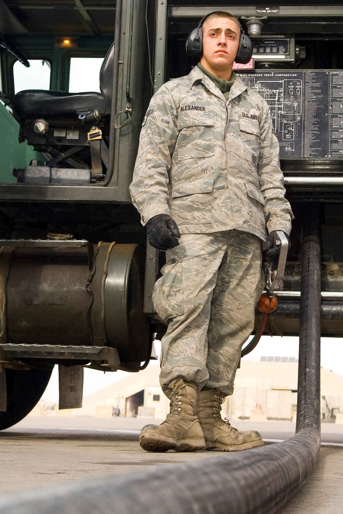 BALAD AIR BASE, Iraq -- Airman 1st Class David Alexander, a 332nd Expeditionary Logistics Readiness Squadron fuels distribution operator, stands next to his 6,000 gallon fuel truck as he pumps gas into an aircraft on the flightline. The 332nd ELRS Fuels Management Flight collectively pumped more than 15 million gallons of fuel during their four-month deployment. Airman Alexander is deployed from Holloman Air Force Base, N.M. (U.S. Air Force photo/ Staff Sgt. Travis Edwards)