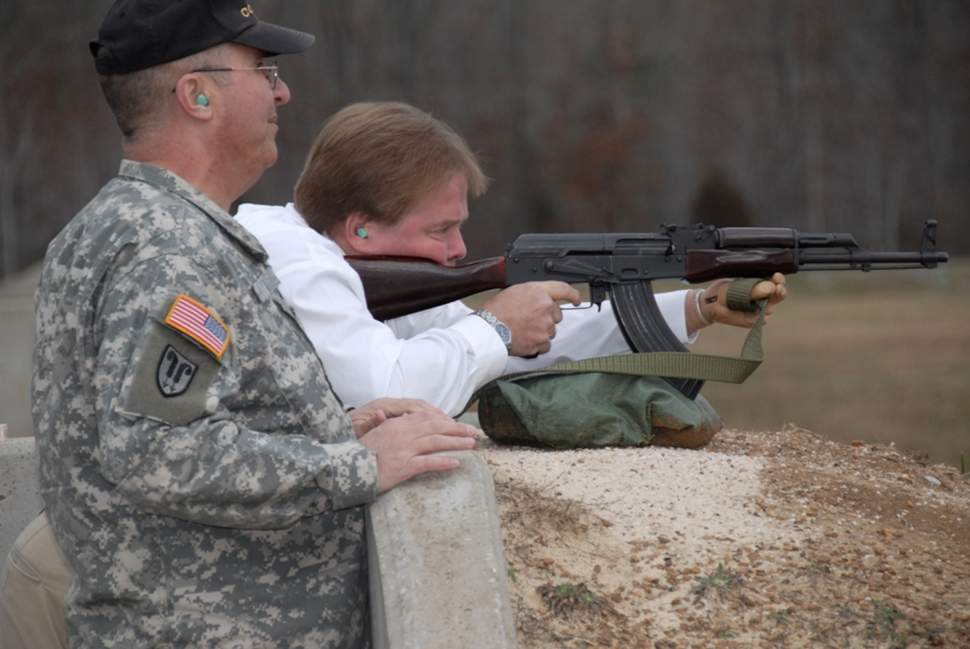 Tennessee Army National Guard and Tullahoma Training Site Commander Maj. William Nelms, watches the senator fire a AK-47 on the 25-300 meter combat range at Arnold Air Force Base. The new state senator visited Arnold Engineering Development Center (AEDC) recently along with Warren County Commissioner Bill Zechman and his granddaughter. AEDC Commander Col. Art Huber took the senator on a tour of AEDC test facilities. (Photo by Rick Goodfriend)

