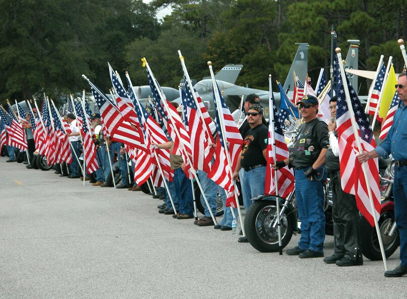 Patriot Guard Riders stand along the entrance to the Air Force Armament Museum to pay respect to fallen service-members during an Afghanistan-Iraq War Memorial Portrait Mural dedication ceremony Jan. 10. The memorial displays ceramic pictures of each Florida-native servicemember killed in Afghanistan or Iraq since Sept. 11, 2001. The event was organized by the Military Order of the Purple Heart. (U.S. Air Force Photo/Master Sgt. Buffy Galbraith)