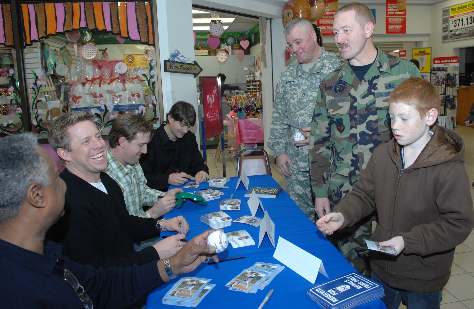 WHITEMAN AIR FORCE BASE, Mo. – Kansas City Royals players Luke Hochevar, Brandon Duckworth, John Buck and Alumni and Hall of Famer Frank White sign autographs for Team Whiteman members at the base exchange Jan. 19. Members of the Royals and Fox Sports News visited the base to sign autographs and participate in a B-2 tour. (U.S. Air Force photo/Airman 1st Class Cory Todd)