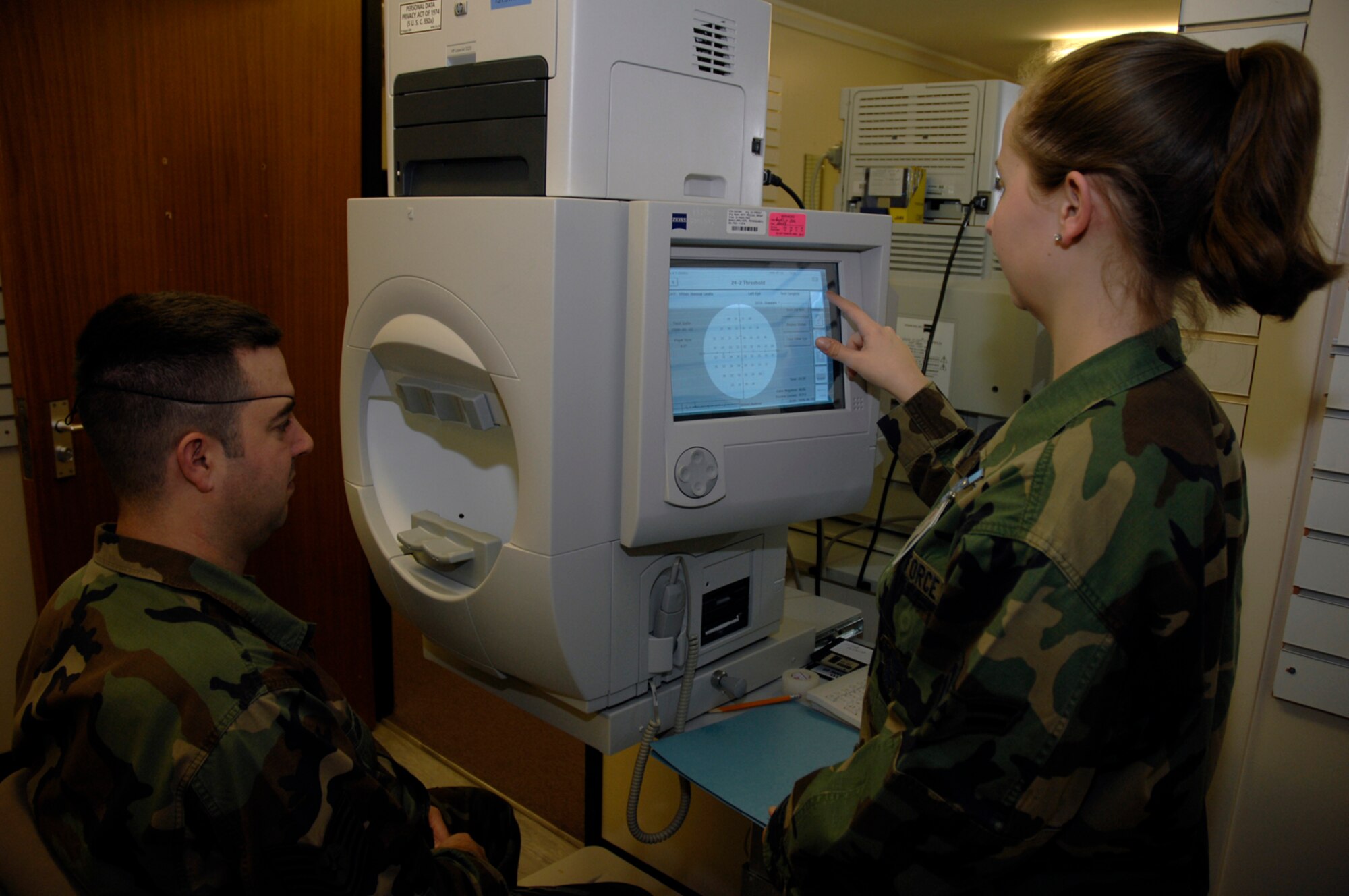 Airman 1st Class Larissa Labarbera, 48th Aerospace Medicine Squadron optometry technician, gives her patient a visual field test measuring all areas of eyesight including peripheral vision, Jan. 22 at RAF Lakenheath, England. (U.S. Air Force photo by Airman 1st Class Erika Brooke) 