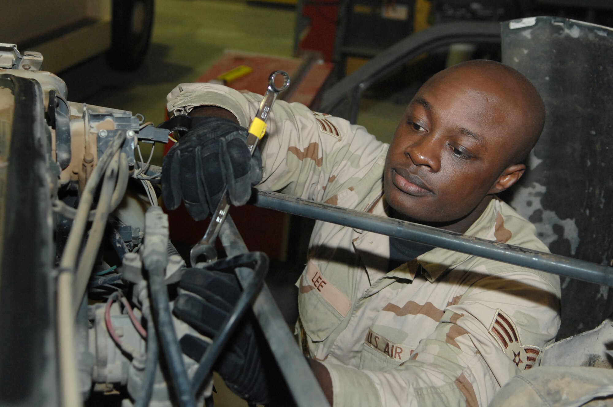 BALAD AIR BASE, Iraq -- Senior Airman Dayson Lee, 332nd Expeditionary Logistics Readiness Squadron vehicle technician, fixes an air brake valve on a tractor trailer here, Jan 23. The valve controls the braking system for the vehicle and the load that it carries. Airman Lee is deployed from Royal Air Force Lakenheath, England. (U.S. Air Force photo/ Senior Airman Julianne Showalter)