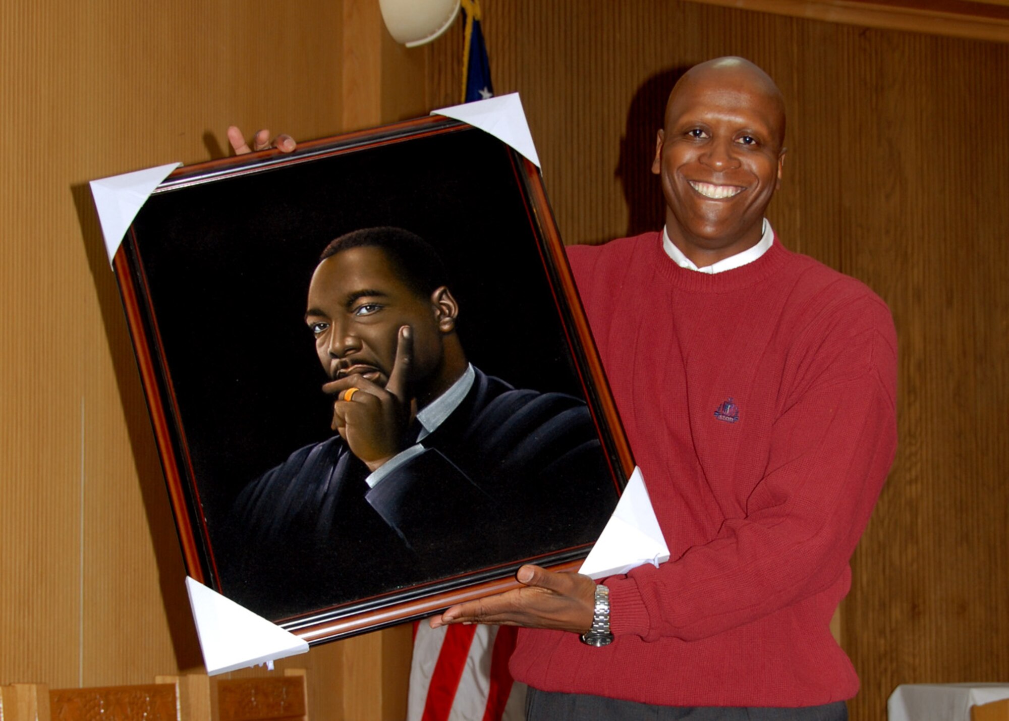 OSAN AIR BASE, Republic of Korea -- Colonel Thomas J. Hasty III, Seventh Air Force Judge Advocate General, holds up a painting of Dr. Martin Luther King Jr., a gift presented to him for providing a speech covering Dr King's life and achievements during Martin Luther King Jr. Day commemorative march and observance.  (U. S. Air Force photo by Senior Master Sgt Marvin Krause)