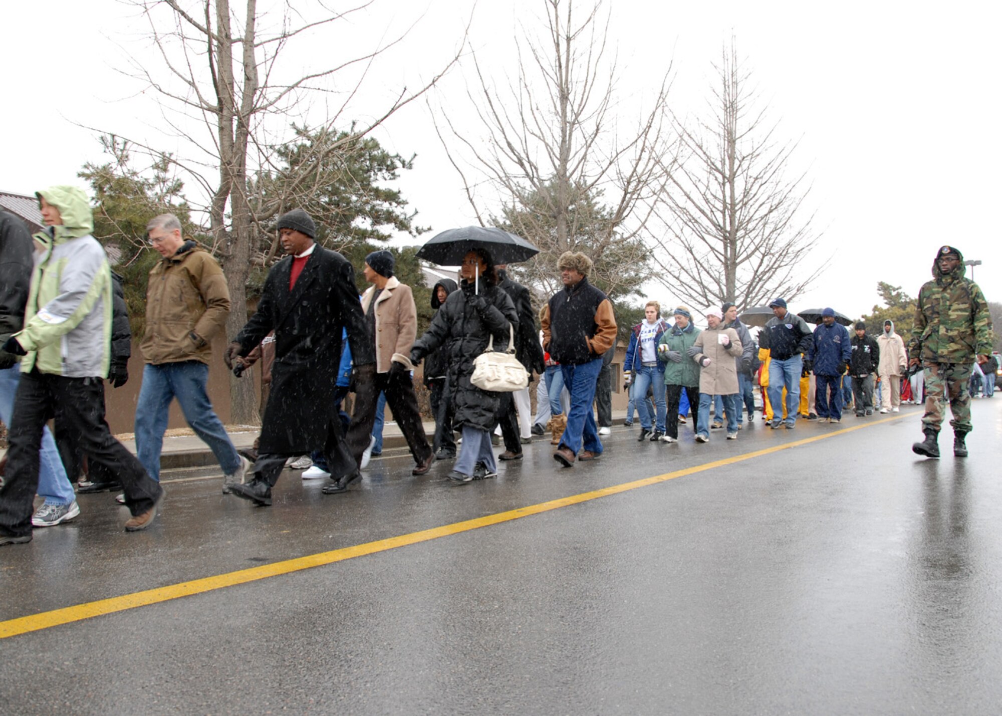 OSAN AIR BASE, Republic of Korea -- Team Osan members participate in Dr. Martin Luther King Jr. Day's commemorative march from Osan's main gate to the base chapel.  (U. S. Air Force photo by Senior Master Sgt Marvin Krause)