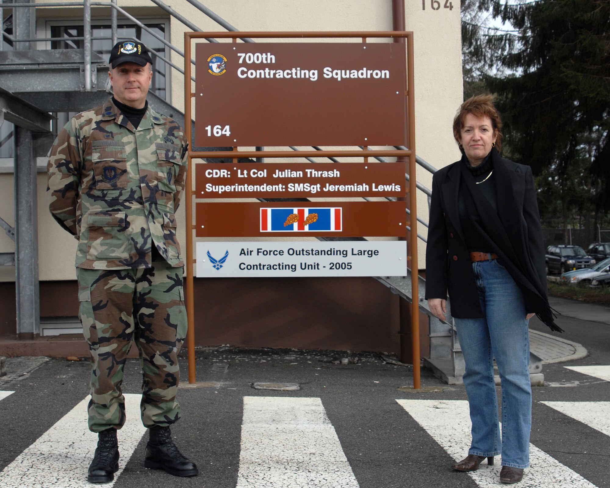 Lt. Col. Julian Thrash, 700th Contracting Squadron commander, and Marianne Seufert, director of Business and Operations, pose for a photo in front of their squadron sign Jan. 18, at Rhine Ordnance Barracks. The 700th Contracting Squadron is a unit made up of Army, Air Force and civilian personnel that perform day –to- day contracting missions. (U.S. Air Force Photo/A1C Kenny Holston)

