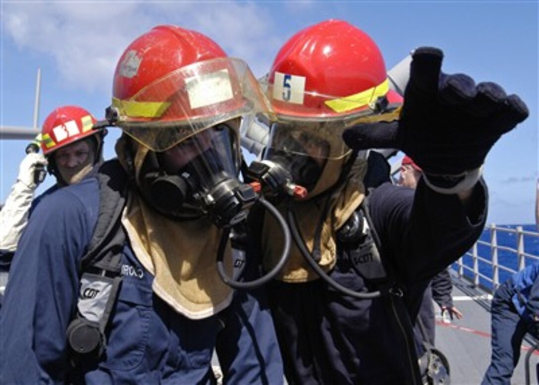 U.S. Navy rescue and assistance team members discuss their plan of attack.